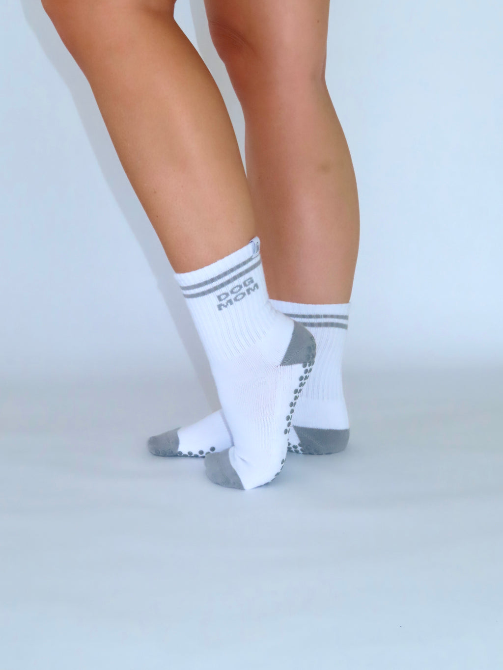 Dog Mom grip socks on feet, side view